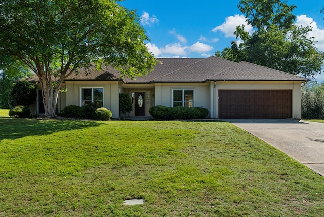 7096 Southwind Ct, Columbus, GA 31909 - view of front facade with an attached garage, driveway, a front yard, and stucco siding