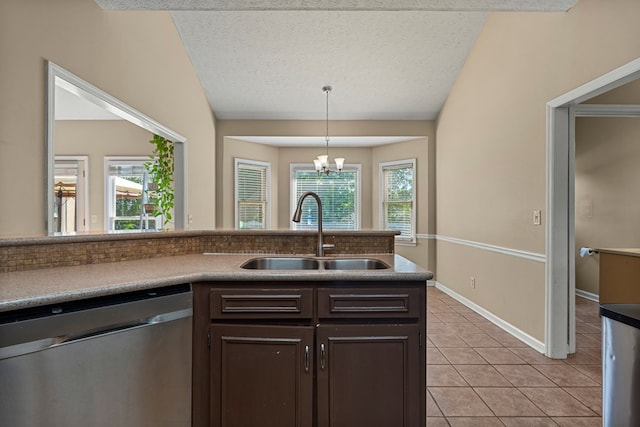 7096 Southwind Ct, Columbus, GA 31909 - kitchen featuring stainless steel dishwasher, a sink, dark brown cabinets, light tile patterned floors, and decorative light fixtures