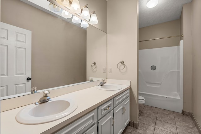 7096 Southwind Ct, Columbus, GA 31909 - bathroom with double vanity, toilet, tub / shower combination, and a textured ceiling