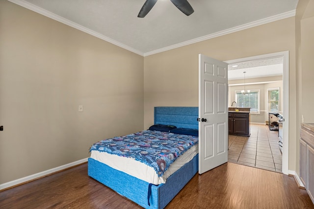7096 Southwind Ct, Columbus, GA 31909 - bedroom featuring ornamental molding, wood finished floors, baseboards, a sink, and a ceiling fan
