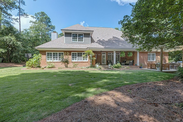 5023 Masters Ln, Columbus, GA 31909 - view of front of home featuring a chimney, a front yard, brick siding, and roof with shingles