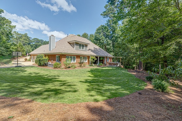 5023 Masters Ln, Columbus, GA 31909 - back of house featuring a chimney, a yard, brick siding, and a shingled roof