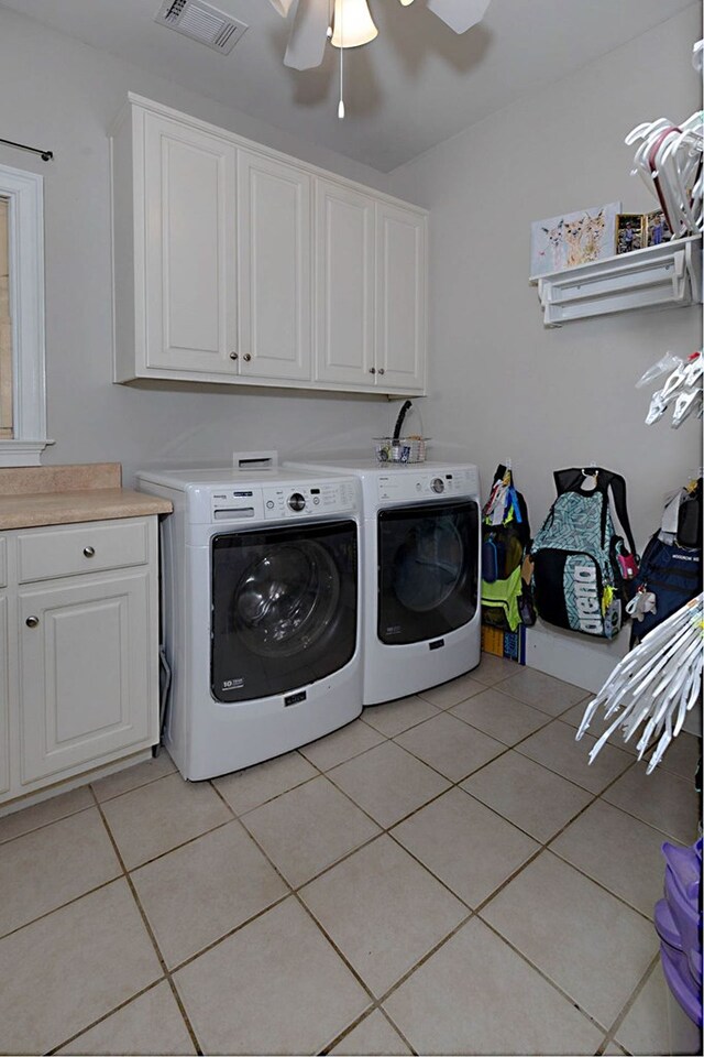 5023 Masters Ln, Columbus, GA 31909 - laundry room with cabinet space, washing machine and dryer, light tile patterned floors, and a ceiling fan