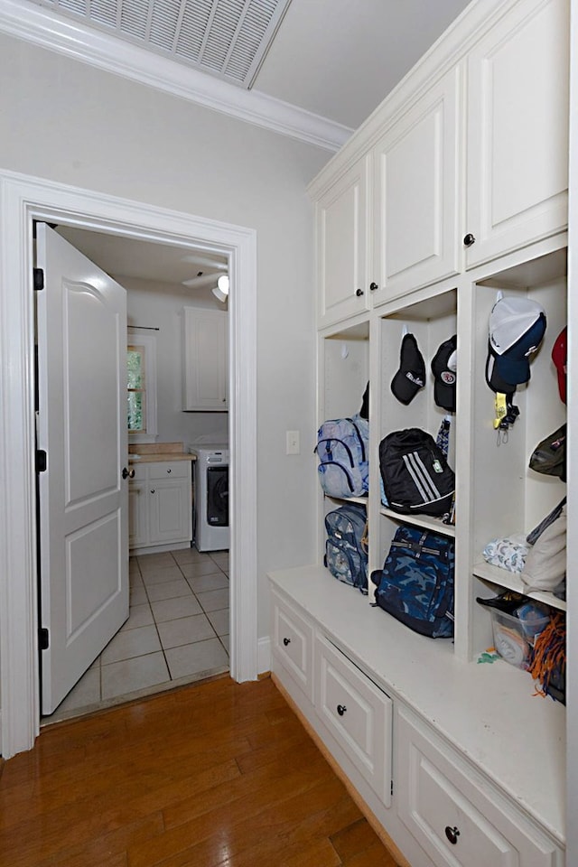 5023 Masters Ln, Columbus, GA 31909 - mudroom with washer / clothes dryer, crown molding, and light wood-style floors