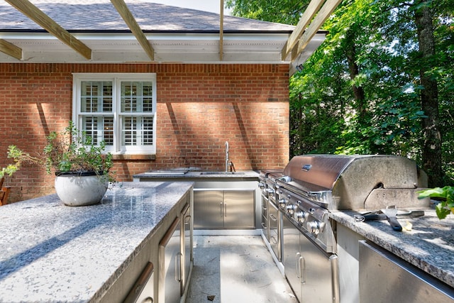 5023 Masters Ln, Columbus, GA 31909 - view of patio featuring a sink and an outdoor kitchen