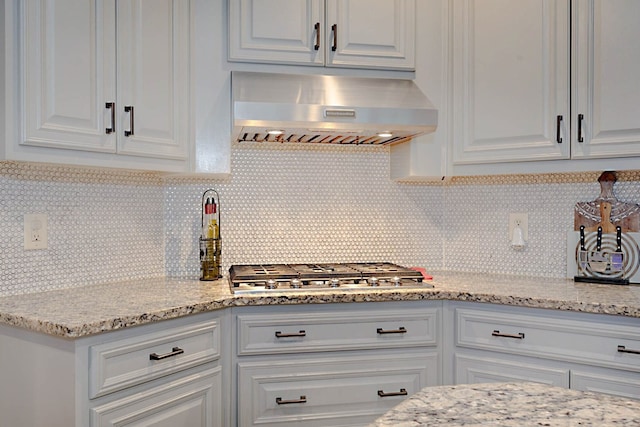 5023 Masters Ln, Columbus, GA 31909 - kitchen featuring wall chimney exhaust hood, stainless steel gas stovetop, white cabinets, and backsplash