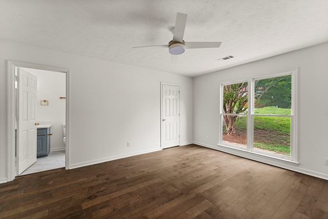 4658 Thoroughbred Ln, Columbus, GA 31909 - unfurnished bedroom with wood-type flooring, baseboards, ensuite bathroom, a textured ceiling, and a ceiling fan