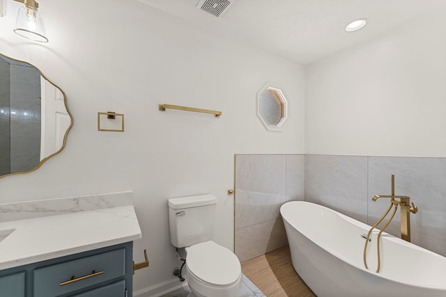 4658 Thoroughbred Ln, Columbus, GA 31909 - full bath featuring a freestanding bath, vanity, toilet, and tile walls