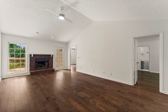 4658 Thoroughbred Ln, Columbus, GA 31909 - unfurnished living room featuring lofted ceiling, dark wood-style flooring, a textured ceiling, a ceiling fan, and a fireplace