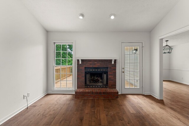 4658 Thoroughbred Ln, Columbus, GA 31909 - unfurnished living room with wood finished floors, a fireplace, and baseboards