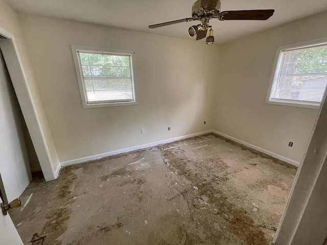 unfurnished room featuring ceiling fan, baseboards, and a healthy amount of sunlight