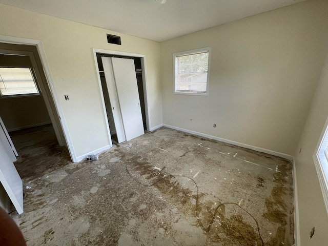unfurnished bedroom featuring a closet and baseboards