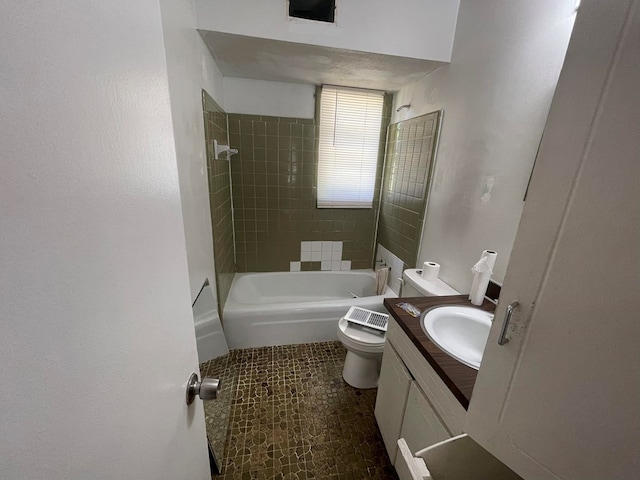 bathroom with toilet, vanity, and shower / washtub combination