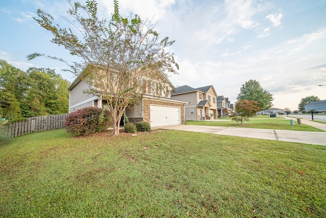 view of front of home with a front lawn and a garage