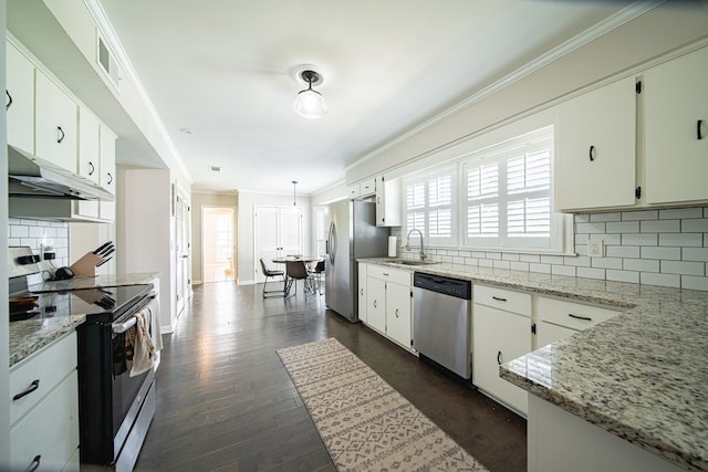 kitchen featuring stainless steel appliances, ornamental molding, tasteful backsplash, under cabinet range hood, and white cabinets