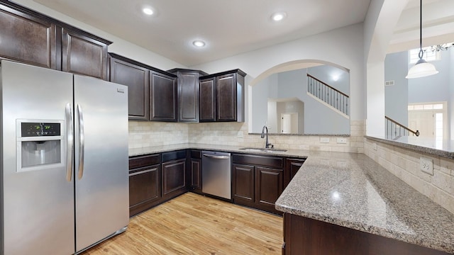 7315 San Vista Dr, Columbus, GA 31909 - kitchen featuring appliances with stainless steel finishes, a sink, dark brown cabinetry, light stone countertops, and recessed lighting