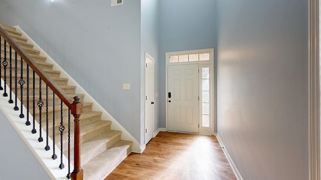 7315 San Vista Dr, Columbus, GA 31909 - entryway with light wood-style floors, baseboards, stairs, and a towering ceiling