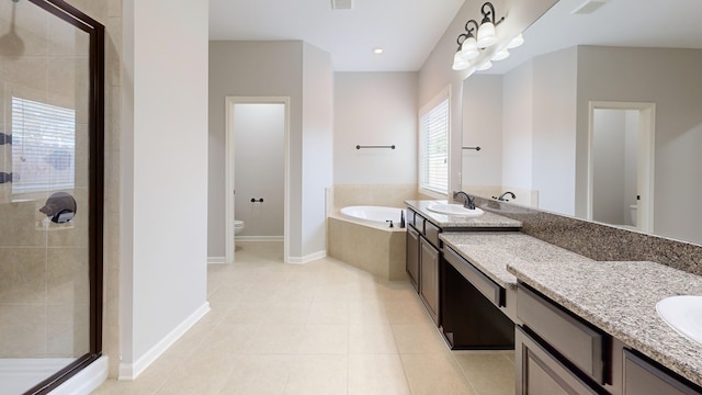 7315 San Vista Dr, Columbus, GA 31909 - bathroom featuring toilet, a stall shower, a garden tub, vanity, and baseboards