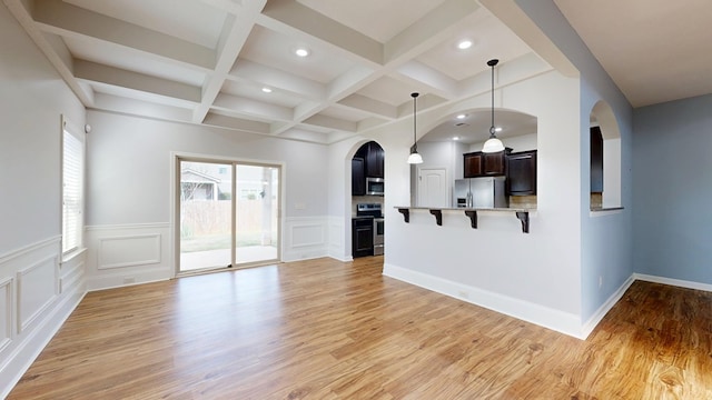 7315 San Vista Dr, Columbus, GA 31909 - unfurnished living room with arched walkways, plenty of natural light, beam ceiling, recessed lighting, and light wood-style floors
