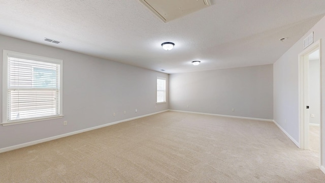 7315 San Vista Dr, Columbus, GA 31909 - empty room featuring light carpet, attic access, baseboards, and a textured ceiling