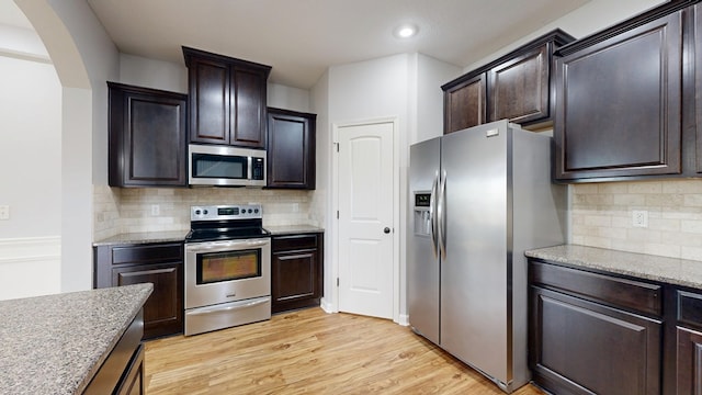 7315 San Vista Dr, Columbus, GA 31909 - kitchen featuring stainless steel appliances, arched walkways, backsplash, light wood-style flooring, and recessed lighting