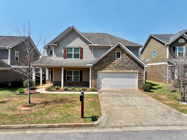 7315 San Vista Dr, Columbus, GA 31909 - view of front of property featuring concrete driveway, stone siding, a front lawn, and a porch