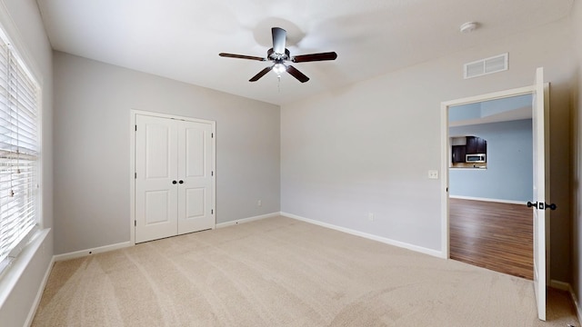 7315 San Vista Dr, Columbus, GA 31909 - unfurnished bedroom with light colored carpet, baseboards, a closet, and ceiling fan