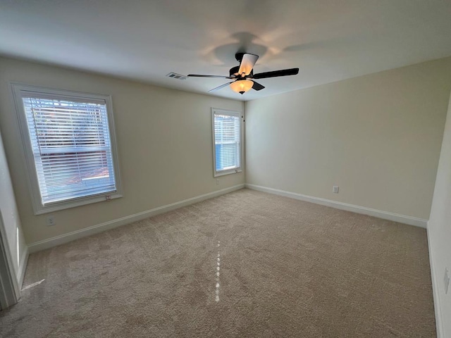 carpeted empty room featuring ceiling fan