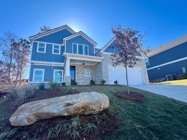 craftsman-style house with central AC, a garage, covered porch, and a front yard