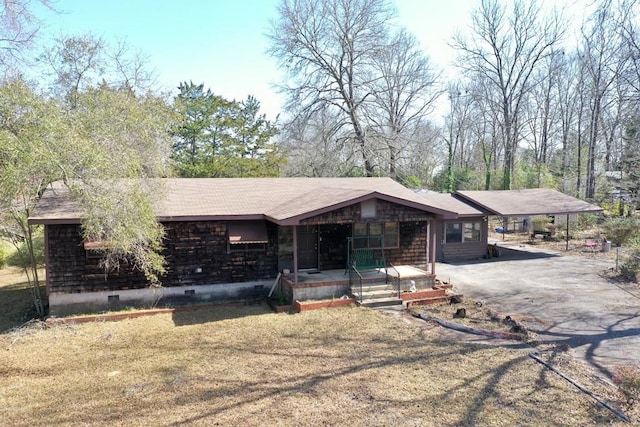 ranch-style house with a carport, a front yard, and covered porch