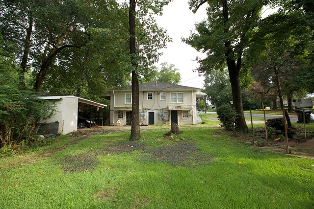 back of property featuring a yard