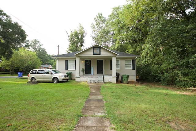 bungalow-style house featuring a porch and a front lawn