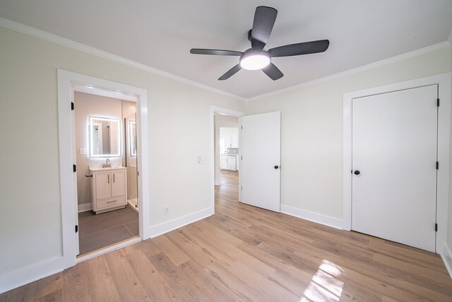 35 Dogwood St, West Point, GA 31833 - unfurnished bedroom featuring light wood-type flooring, crown molding, baseboards, connected bathroom, and ceiling fan