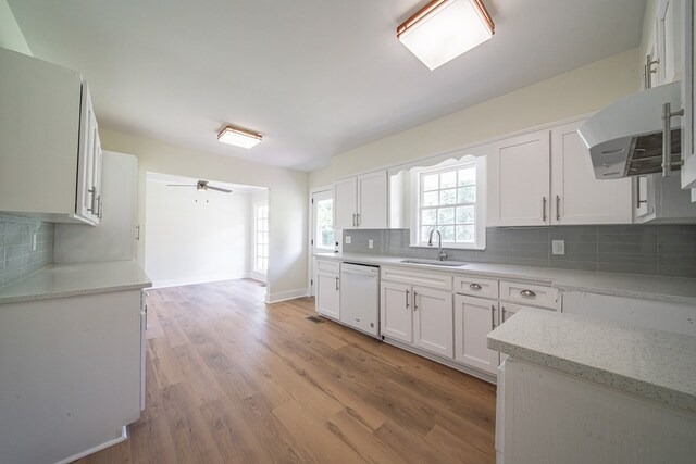 35 Dogwood St, West Point, GA 31833 - kitchen with white dishwasher, a sink, extractor fan, and white cabinetry
