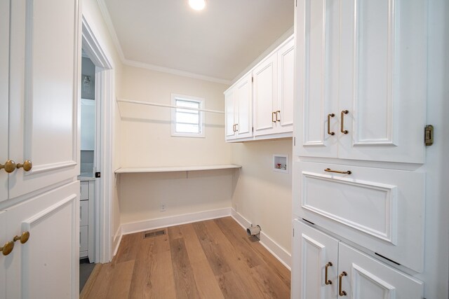 35 Dogwood St, West Point, GA 31833 - laundry area featuring baseboards, hookup for a washing machine, light wood-type flooring, ornamental molding, and cabinet space