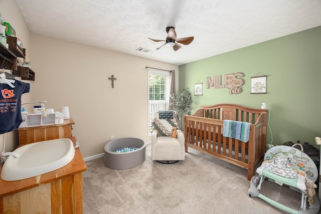6 Lincolnshire Ln, Phenix City, AL 36870 - carpeted bedroom featuring a textured ceiling, a ceiling fan, a sink, and baseboards