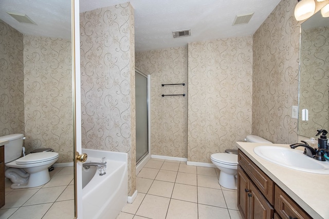6 Lincolnshire Ln, Phenix City, AL 36870 - full bath featuring toilet, tile patterned flooring, vanity, a garden tub, and a stall shower