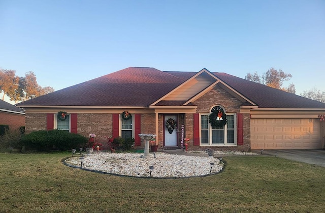 ranch-style house featuring a garage and a front lawn