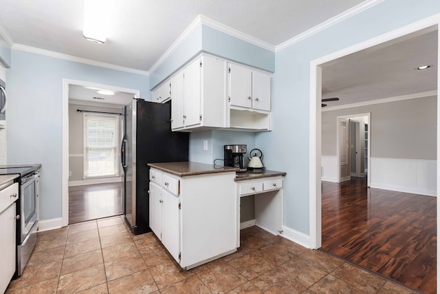 4 David Ct, Columbus, GA 31909 - kitchen with appliances with stainless steel finishes, white cabinets, dark countertops, built in desk, and ornamental molding