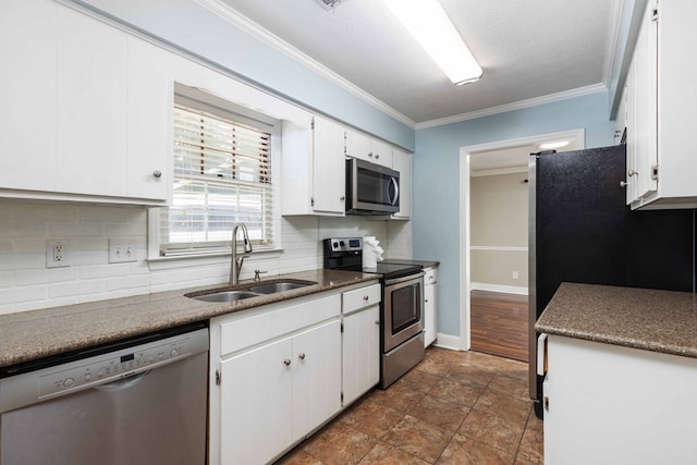 4 David Ct, Columbus, GA 31909 - kitchen featuring appliances with stainless steel finishes, backsplash, white cabinetry, ornamental molding, and dark countertops