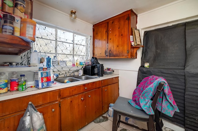 kitchen featuring sink and light tile patterned flooring