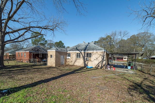 rear view of property featuring a yard and cooling unit