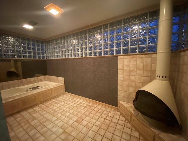 bathroom with tile patterned floors and tile walls