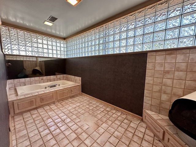 bathroom featuring tile patterned flooring and a bathing tub