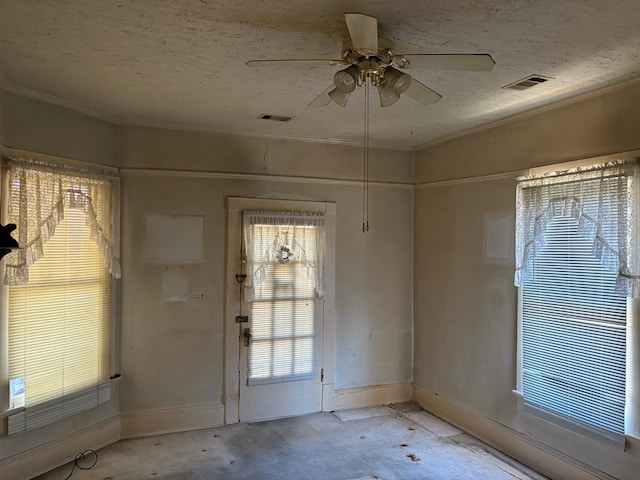 interior space featuring baseboards, ceiling fan, and visible vents