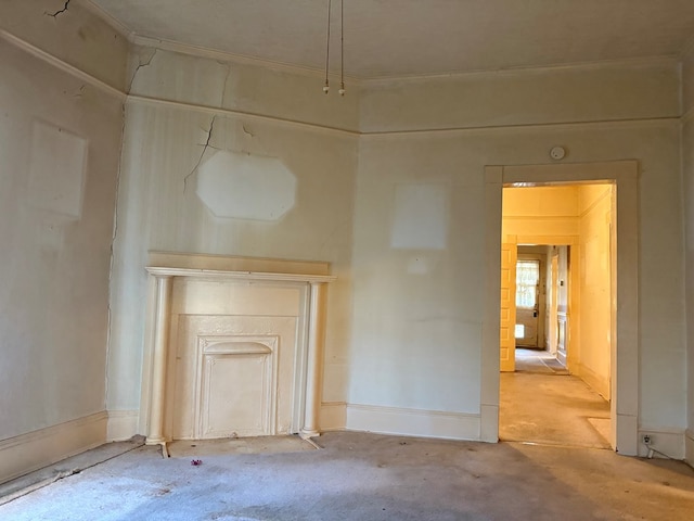 unfurnished living room featuring baseboards and carpet