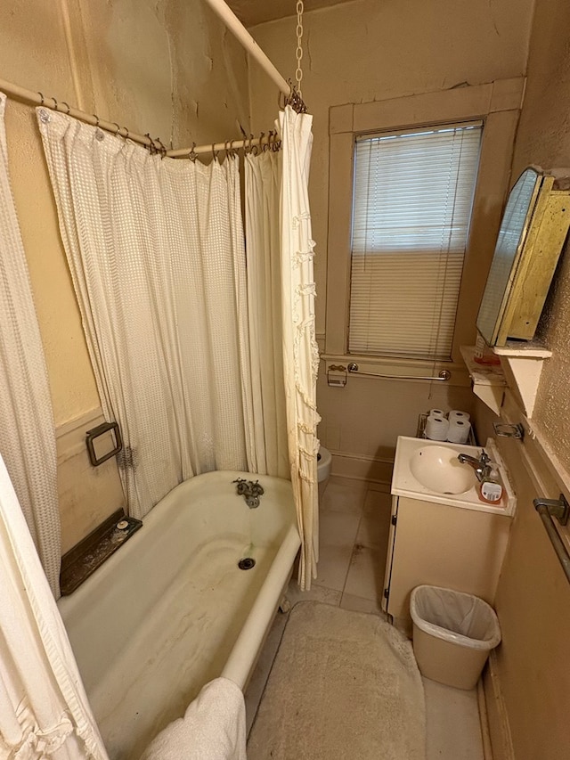 full bathroom featuring vanity, tile patterned flooring, toilet, and shower / bath combo with shower curtain