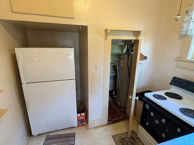 kitchen featuring electric range oven, freestanding refrigerator, baseboards, light floors, and refrigerator