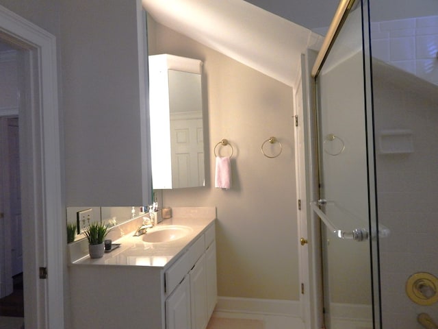 full bathroom with a shower with shower door, vanity, and baseboards