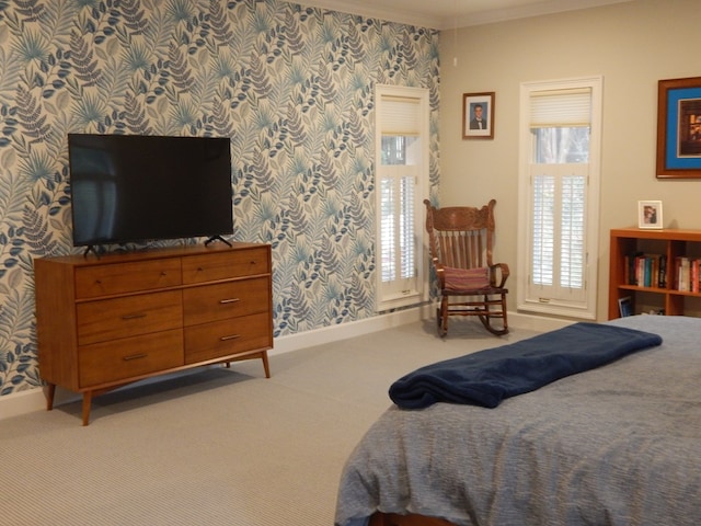 bedroom featuring light colored carpet, crown molding, baseboards, and wallpapered walls